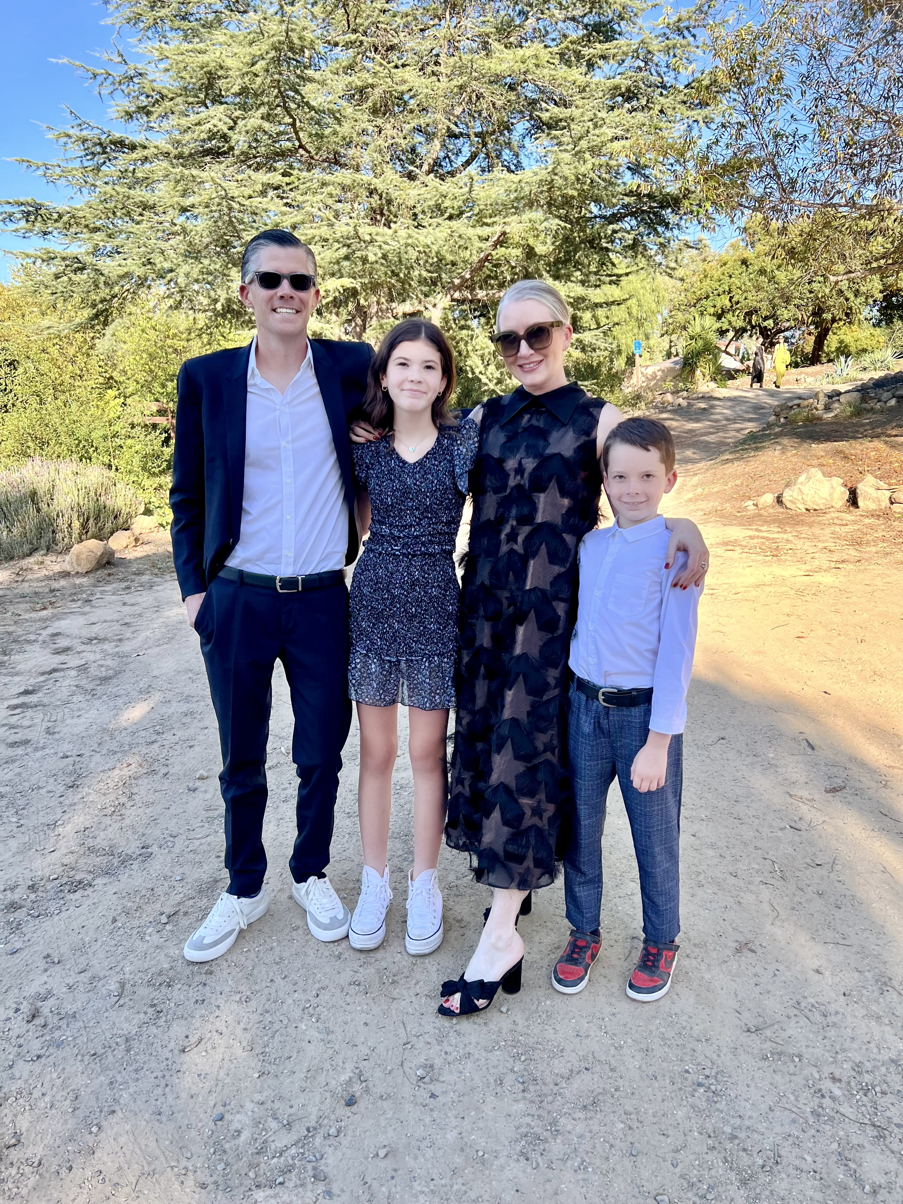 Clea pictured with her husband, daughter, and son posing for a picture outside