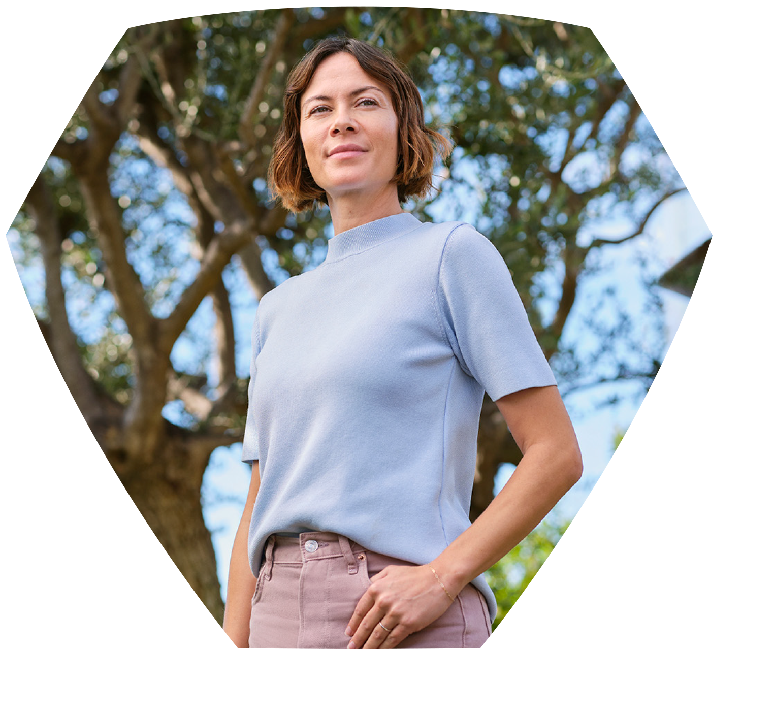 Woman standing in nature smiling